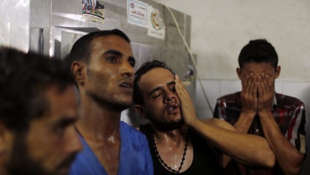 Relatives of Palestinian children react following their death at a hospital in Gaza.