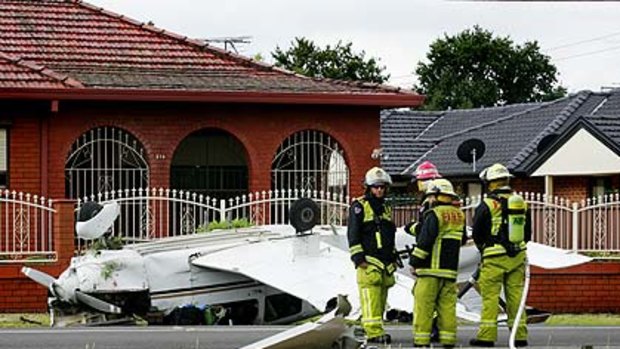 Road to ruin ... the upturned aircraft after it crashed in Brenan Street, Smithfield.