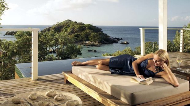 A daybed with views on a villa deck.