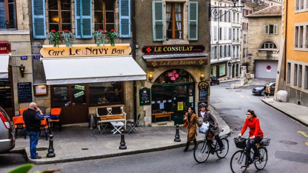 Cyclists and cafe bars at the Vieille Ville (Old Town) Geneva, Switzerland.