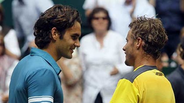 Lleyton Hewitt and  Roger Federer shake hands after their match.