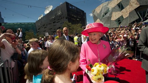 Royal spring: flowers were in abundance as children greeted the Queen at Federation Square.