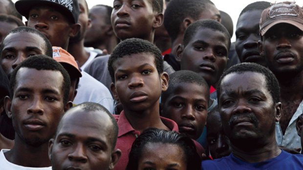Slow relief ... Haitians wait for food and water in Leogane.