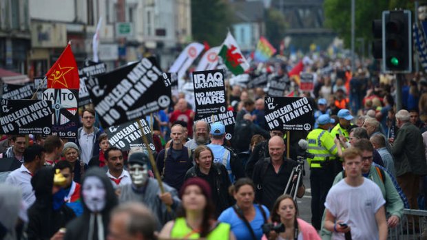 Meanwhile, outside: A protest march against the NATO Summit in Wales.