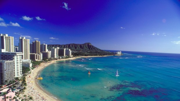 Soak up the sun at Waikiki Beach in Hawaii or take a lesson in surfing.