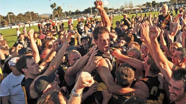 Party time: Mirboo North celebrates its thrilling one-point win over Newborough in the Mid Gippsland league.