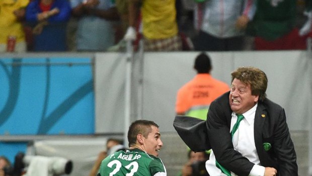 Mexico's coach Miguel Herrera (right) and Mexico's defender Paul Aguilar share a happy moment.