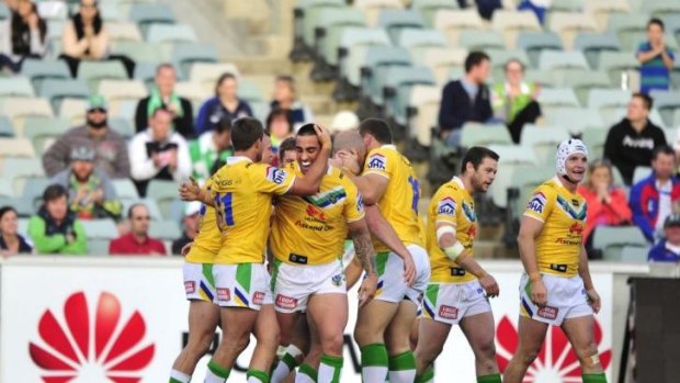 Raiders centre Paul Vaughan celebrates with his team after a try, in their win against the North Queensland Cowboys.