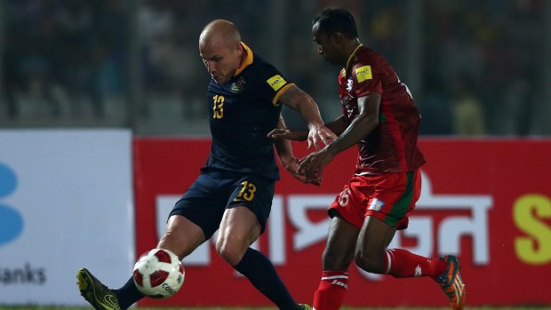 Crucial win: Aaron Mooy battles for possession during Australia's win over Bangladesh.