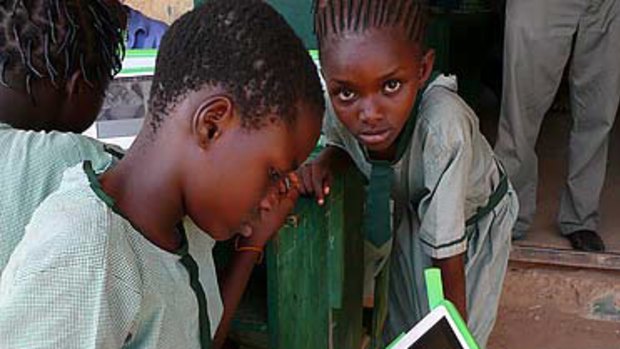 Girls try the XO in Nigeria in 2009. The One Laptop Per Child organisation will now adopt tablet devices.