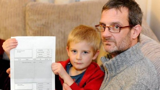 Derek Nash and his five-year-old son Alex, who holds the party no-show invoice in his hands.