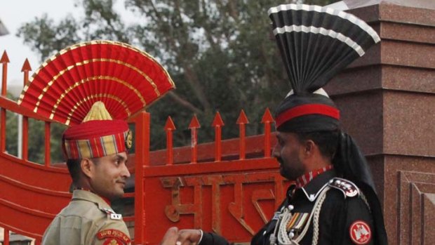 Sign of peaceful times ... a Pakistani Ranger and an Indian Border Security Force officer shake hands during the daily parade at the Pakistan-India joint check-post at Wagah border, on the outskirts of Lahore.
