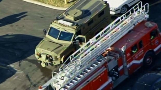 Sn armored vehicle and fire engine arrive at Arapahoe High School in Centennial, Colorado.