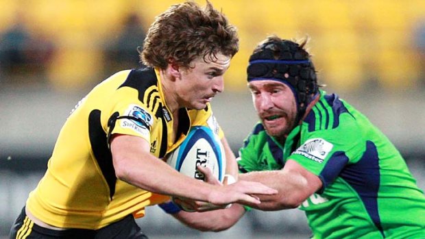 Beauden Barrett of the Hurricanes is tackled by Andrew Hore of the Highlanders.