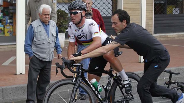 Dropped ... Mark Cavendish of Britain is helped by a mechanic after having a flat tyre during the Milan-San Remo Classic.