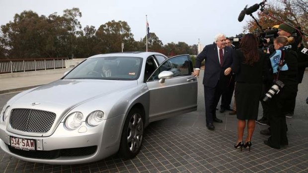 Space hog: Clive Palmer alights from his Bentley.