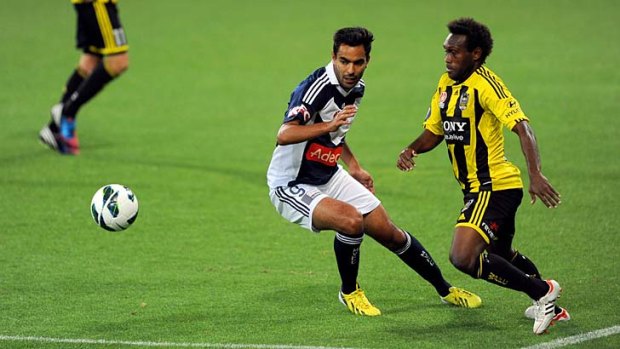 Stepping up: Wellington Phoenix's Benjamin Totori leads Melbourne Victory's Marcos Flores in the race for the ball at AAMI Park.