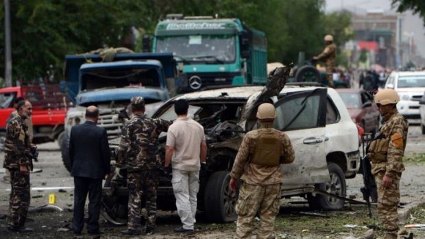 A damaged car at the site of a suicide car bomb attack on the convoy of Afghan presidential candidate Abdullah Abdullah.