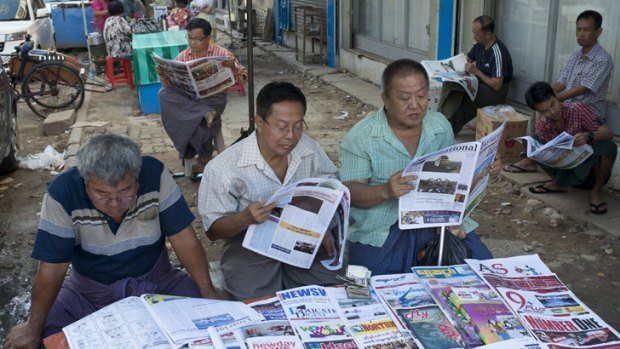 Burmese men read the morning papers.
