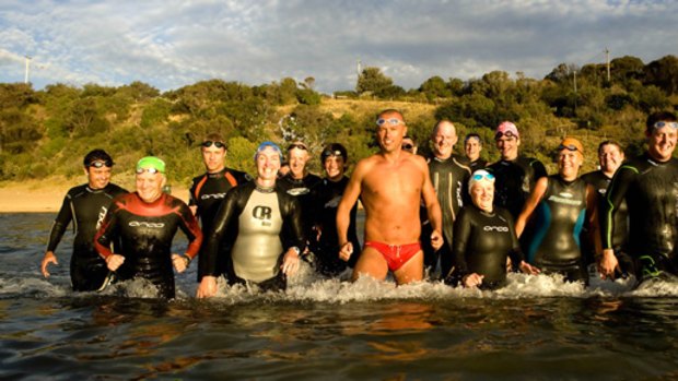 John Van Wisse (centre) teaches members of his ocean swimming class at Half Moon Bay how to swim in the equivalent of a rugby scrum.