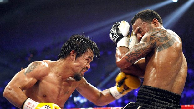 Manny Pacquiao (left) lands a punch during his welterweight title fight with Shane Mosley.