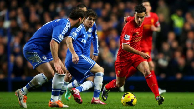 Eye on the future: Oscar, centre, challenges Liverpool's Philippe Coutinho at Stamford Bridge on December 29. The Brazilian is one of several younger signings that will offset the need for Chelsea to spend big on regeneration.