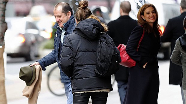 Russel Howcroft, left, and his teenage daughter leave Bar Americain. Helen Kapalos, right, met with CBS news executive Bill Mondora.