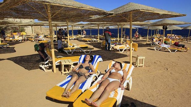 'Bikinis are welcome' ... tourists enjoy the beach in the Red Sea resort town of Sharm el-Sheikh, some 500 kilometres east of Cairo.