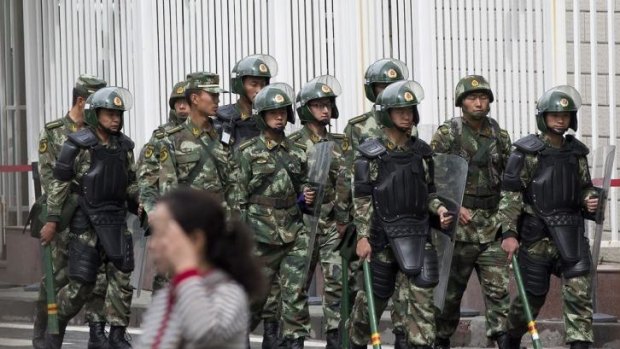 Armed presence: paramilitary policemen patrol near the People's Square in Urumqi, the capital of Xinjiang.