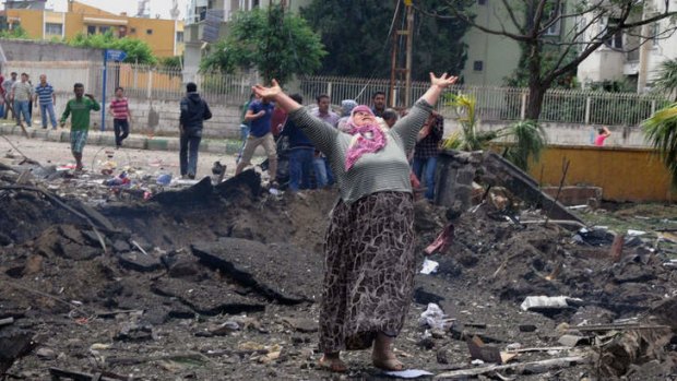 Devastation: A woman in despair at the site of one of the blasts near the Turkey-Syria border.