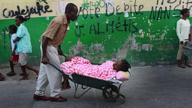 Harsh reality &#8230; a person with cholera is carted to doctors in Haiti.