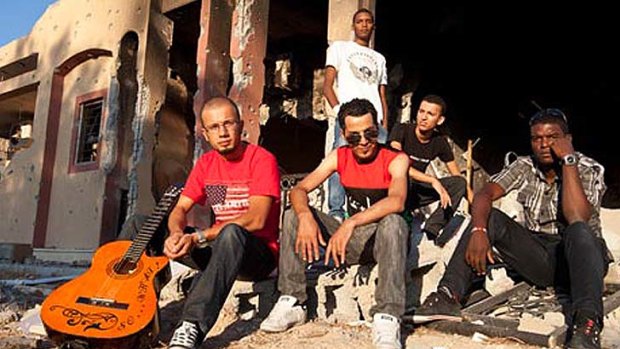 Members of the band FB 17 amid the ruins on Misrata.