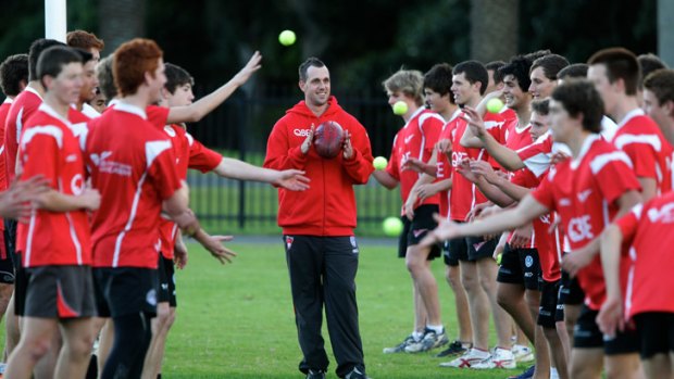 King of the kids: Nick Davis with the Swans’ youth academy team.