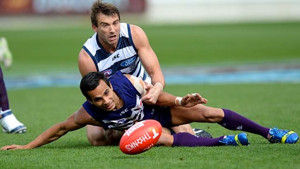 Corey Enright and Danyle Pearce battle for possession at Simonds Stadium.