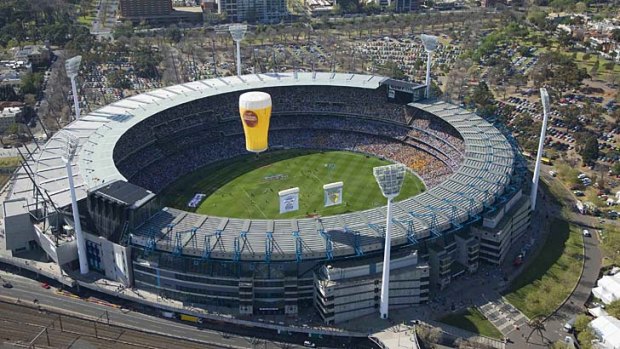 A Carlton Draught hot air balloon flies over the Melbourne Cricket Ground on AFL grand final day.
