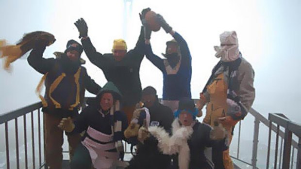 Footy fans rug up in Antarctica.