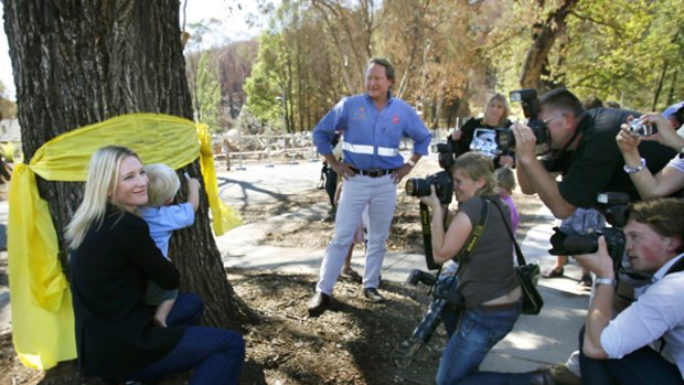 With love: Cate Blanchett and Andrew Forrest attend a picnic at Marysville yesterday. The actress, with Asher Sims, 2, signed the oak tree near the kindergarten.