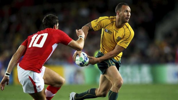 Elusive &#8230; Wallaby Quade Cooper out-steps a Welsh defender during a Rugby World Cup game in Auckland; and inset, as water boy for the Reds against the Chiefs last weekend.