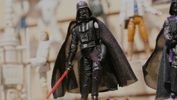 Darth Vader stands amongst other Star-Wars figures on display in the Hasbro showroom during the International Toy Fair.  