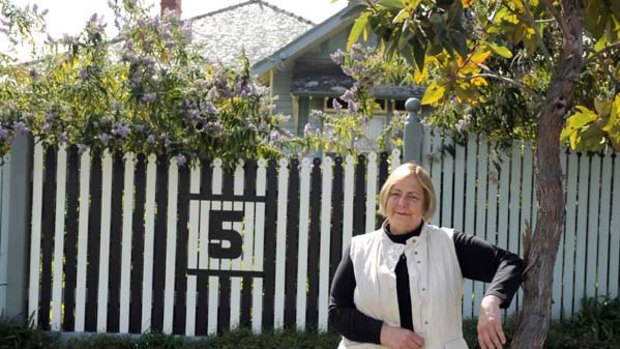 Sue McCarthy with her black-and-white fence for husband Kevin.