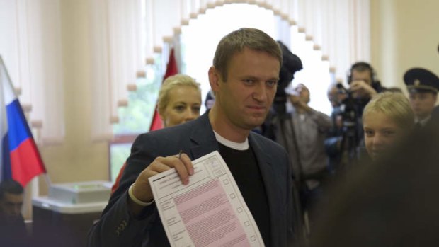 Russian opposition leader Alexei Navalny shows off his ballot at a polling station in Moscow's mayoral election on  Sunday.
