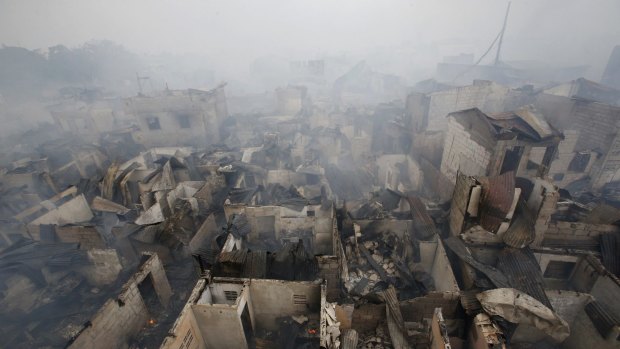 The remains of houses gutted by a fire are pictured at a slum colony in Quezon city, Metro Manila.