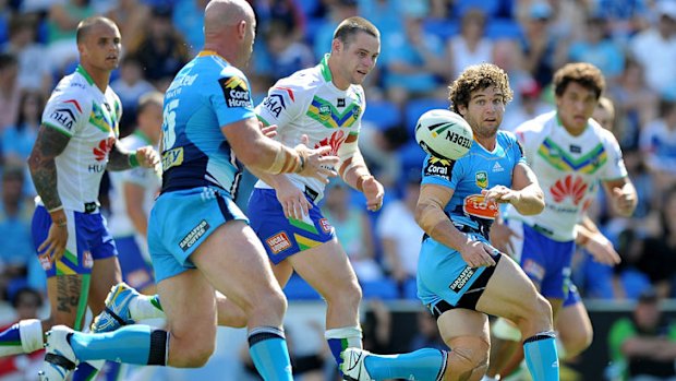 Beau Falloon of the Titans passes the ball during the round two NRL match between the Gold Coast Titans and the Canberra Raiders at Skilled Park on March 17, 2013 on the Gold Coast, Australia.