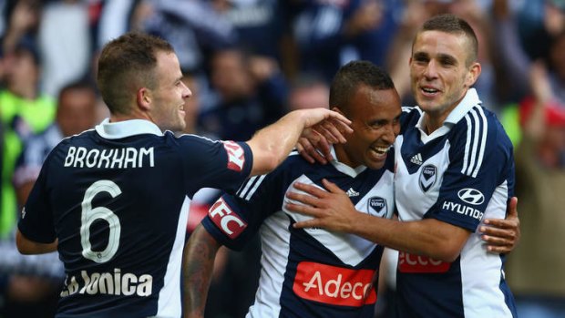 Victory is ours: Archie Thompson celebrates his goal with Leigh Broxham and Diogo Ferreira.