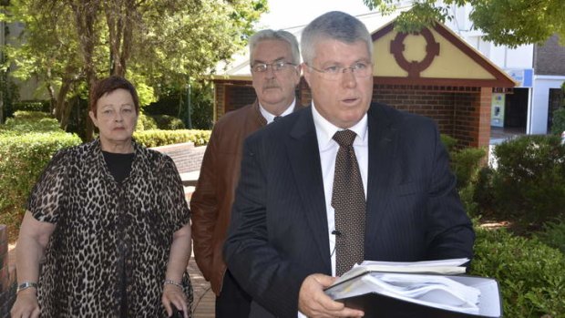 "Deepest sympathy" ... Philip Cameron and his wife look on as solicitor Mark Daly reads a prepared statement.