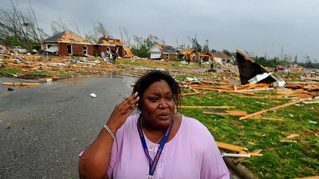 Tamisha Cunningham, who suffered an injured leg when her home was destroyed, surveys the damage near Athens, Alabama.