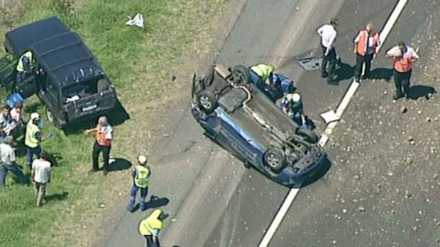 An overturned car on the Hume Highway near the Narellan Interchange.