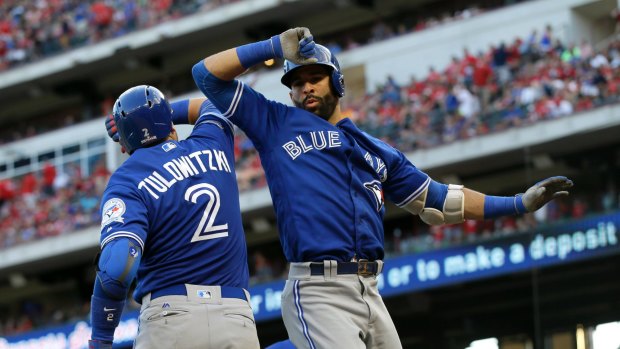 Solid start: Troy Tulowitzki and Jose Bautista celebrate the latter's home run.