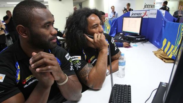Parramatta Eels player Fuifui Moimoi (right), on the phone calling club members to thank them for their support.