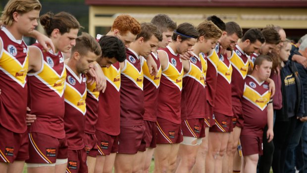 Players line up for a minute's silence before the match between the Lower Plenty Bears and Whittlesea Eagles at Montmorency Park.